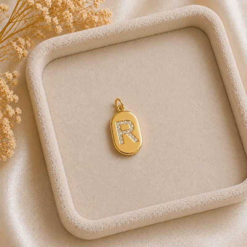 Pingente Letra Oval Cravejada R (19x10mm)